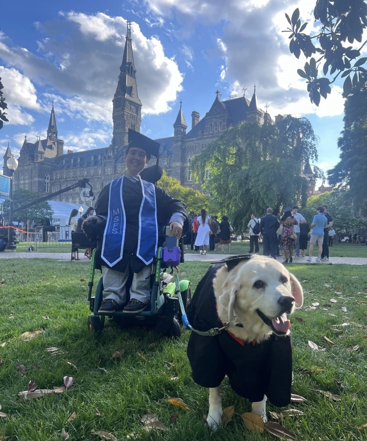 Shea's service dog graduating with her, both in their cap & gown